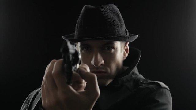 Portrait of a Mafioso in a hat and a black cloak