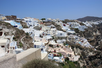 Fototapeta na wymiar White houses with blue roofs in Santorini. Greece