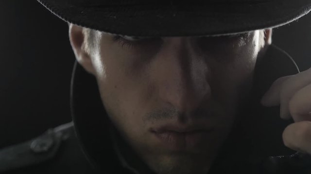 Close up Portrait of gangster in a hat and a black cloak
