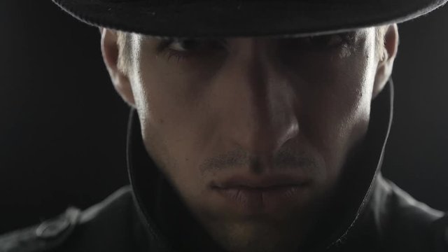 Close up Portrait of gangster in a hat and a black cloak