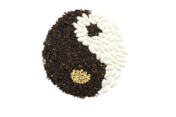 Black rice and white pill forming a yin yang symbol indicate blending of herb and medicine isolated...