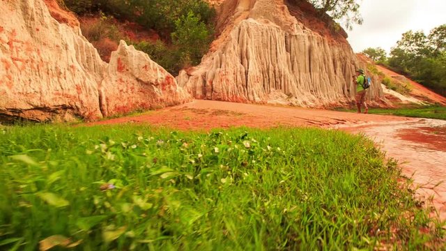 Tourist Walks along Red Waters by Fairy-Stream Rocks Photos