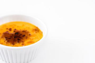 Traditional French creme brulee dessert with caramelized sugar on top, isolated on white background.


