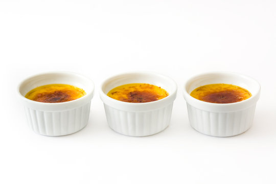 Traditional French creme brulee dessert with caramelized sugar on top, isolated on white background.

