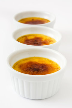 Traditional French creme brulee dessert with caramelized sugar on top, isolated on white background.

