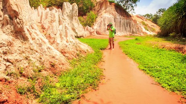 Tourist Walks Barefoot Photos in Fairy-Stream Shallow Water