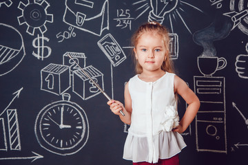 The little smart girl holding a pointer on dark background with business or school picture