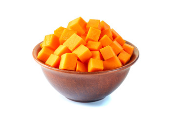 Ceramic  bowl of sliced pumpkin cubes on white