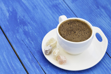 Turkish coffee with delight on wooden background