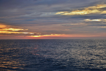 Fototapeta premium Reflective Seas Beneath Sunrise