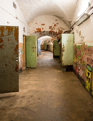 Tallinn Estonia, August 2016: hallway inside of the Patarei, sea fortress prison, with open doors of the prison cells 