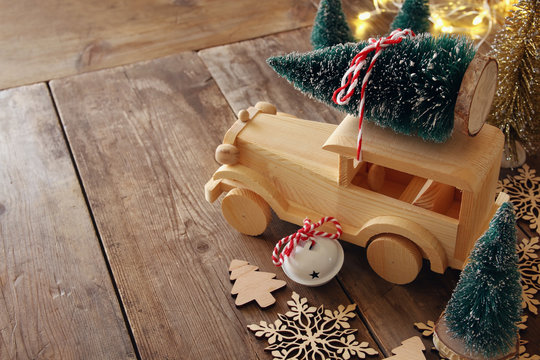 Wooden car carrying a christmas tree on the floor
