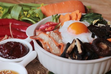 Bibimbap korean food is delicious on wood background.