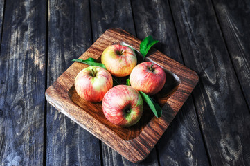 apples in a bowl on the wooden background