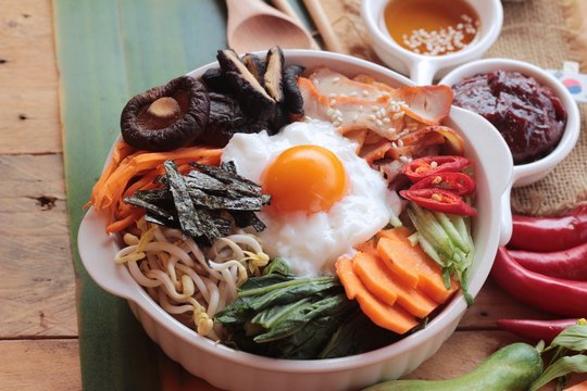 Bibimbap korean food is delicious on wood background.