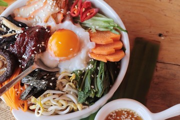 Bibimbap korean food is delicious on wood background.
