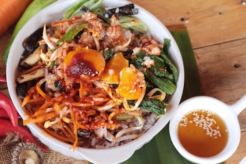 Bibimbap korean food is delicious on wood background.