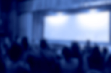 Audience in a theater, on a concert and applauding blurred