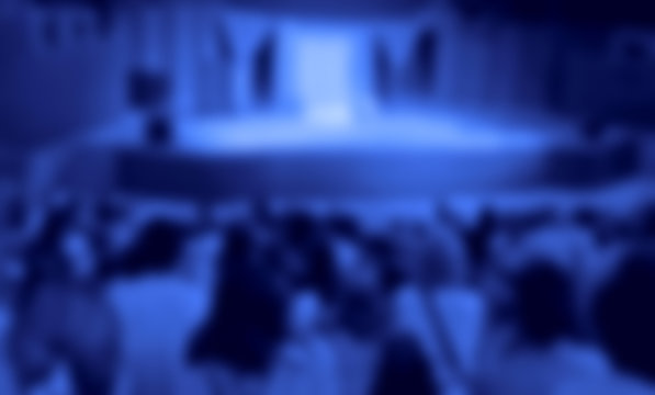 Audience in a theater, on a concert and applauding blurred