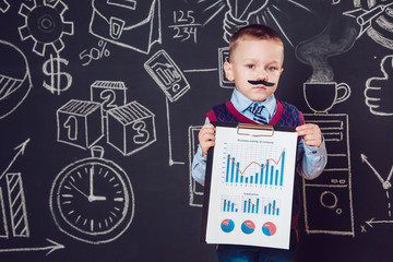 Little boy as a businessman with mustache shows graph of the company's business activities on dark background  pattern