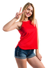 Blonde girl doing victory gesture