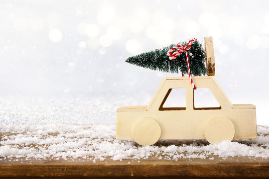 Wooden car carrying a christmas tree