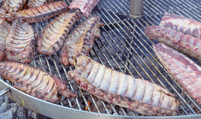 Cooking outdoors. Traditional food of Spain. Big barbecue grill of ribs. Medieval market.