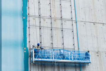 worker working with ourdoor lift outside underconstruction building site for welding metal frame © Quality Stock Arts
