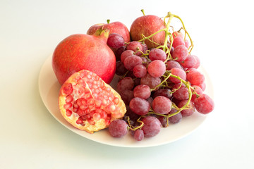 fresh red grapes, apples and pomegranates plate