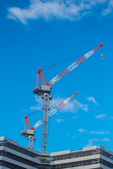 Fototapeta premium tower cranes on the construction of the building in Japan.
