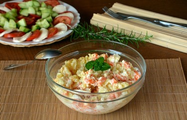 Homemade Potato Salad with Eggs and Carrots On A Glass Bowl On A Wooden Table