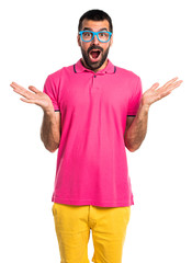 Man with colorful clothes doing surprise gesture