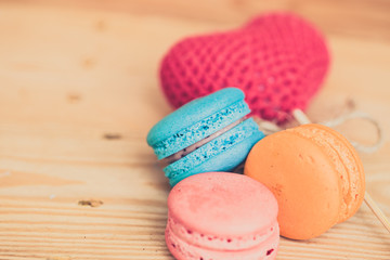 colorful dessert macarons on wood table.