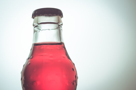 soft drink, red color in glass bottle.