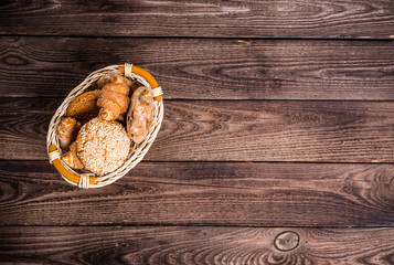 Obraz na płótnie Canvas Assortment of baked bread on wooden table background