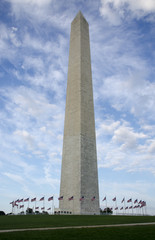 Washington Monument encircled by fifty waving flags on a windy day