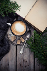 branch of spruce, warm sweater and cup  coffee with sugar
