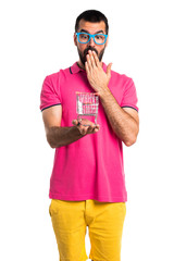 Man with colorful clothes holding a supermarket cart toy