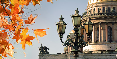 Fototapeta na wymiar Autumn leaves and Saint Isaac Cathedral, St Petersburg, Russia