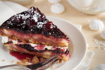 Piece of cherry cake on a white plate