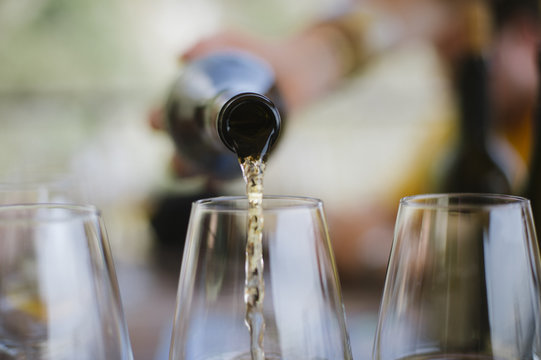 White wine being poured into glasses, Cinque Terre, Italy, Europe