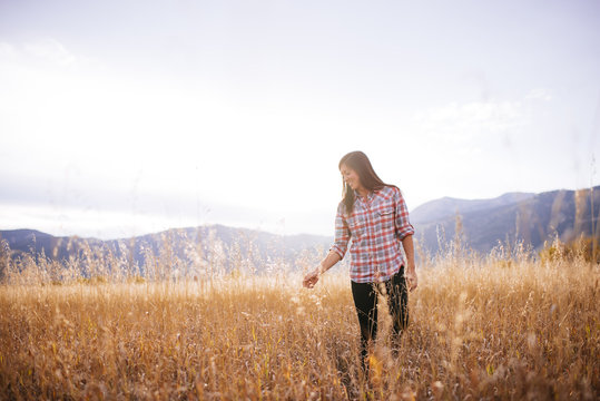 Woman touching grass, Jackson Hole, Jenny Lake, Grand Teton, Wyoming, United States of America