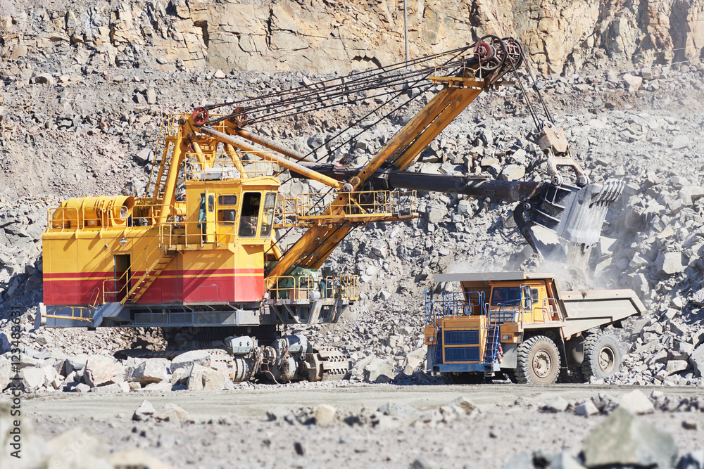 Wall mural excavator loading granite or ore into dump truck at opencast - Wall murals