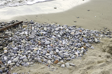 stone on marinella beach in liguria