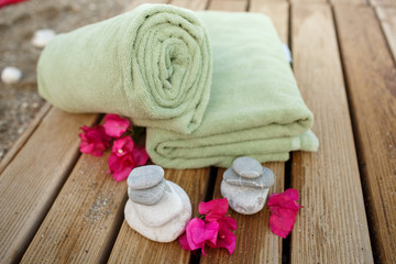 Fototapeta na wymiar Spa and wellness towel and flowers at tropical beach