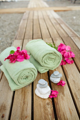 Spa and wellness towel and flowers at tropical beach