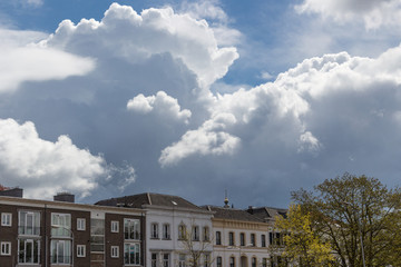 Fototapeta na wymiar Clouds above houses