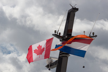 Canadian and Dutch flags on a ship