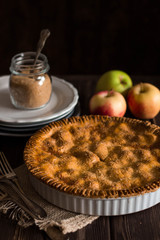 Traditional homemade apple pie on rustic background