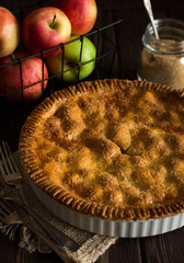Traditional homemade apple pie on rustic background